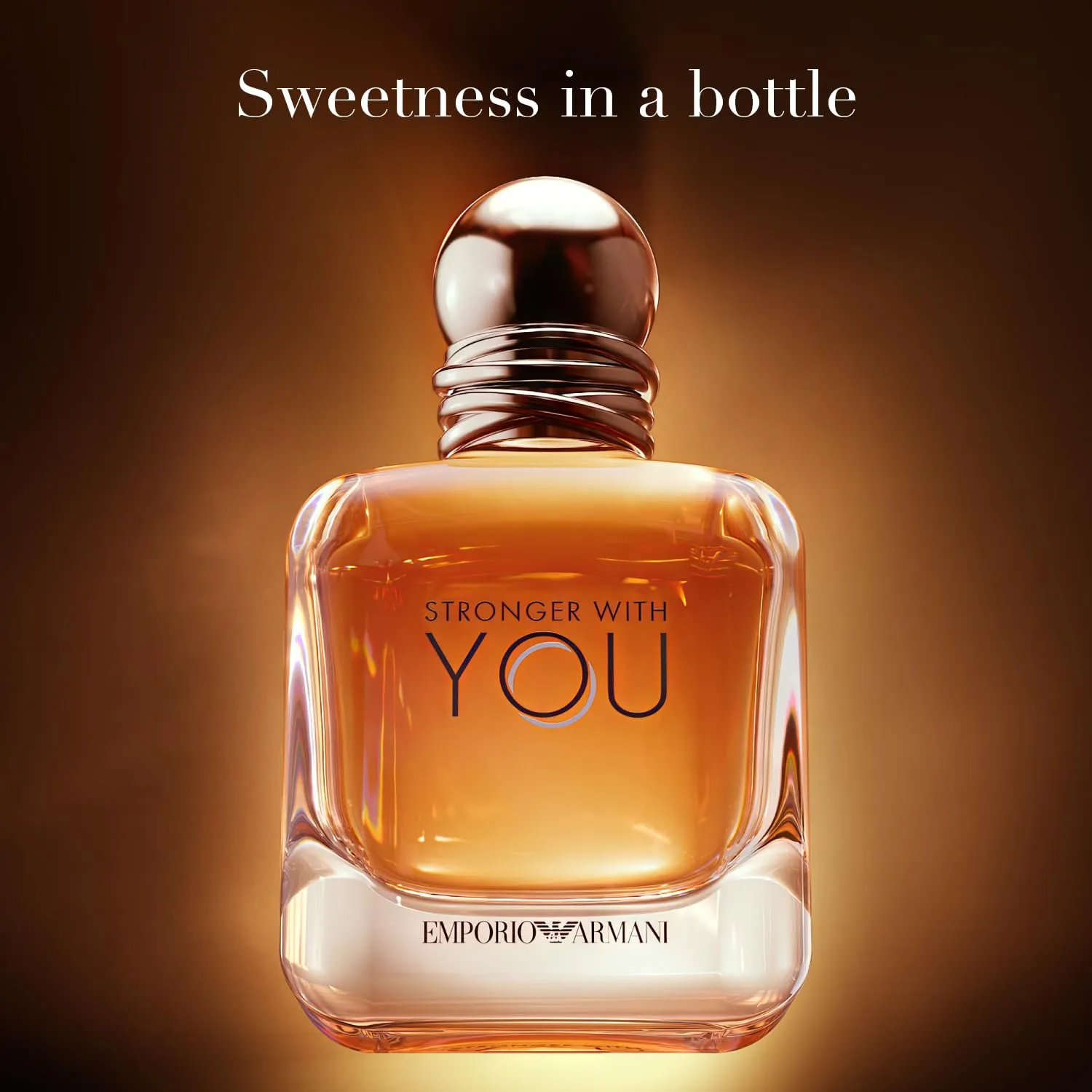 Armani Stronger With You bottle in warm amber light