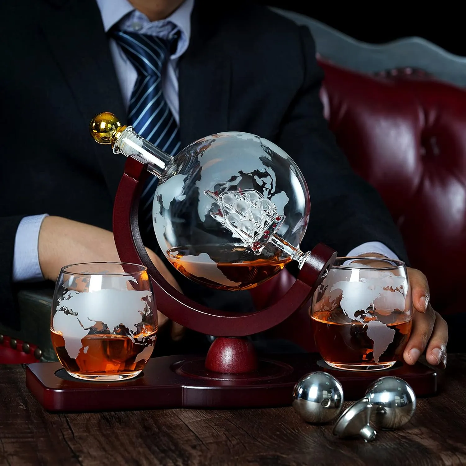 Globe whiskey decanter set styled on a dark wooden table