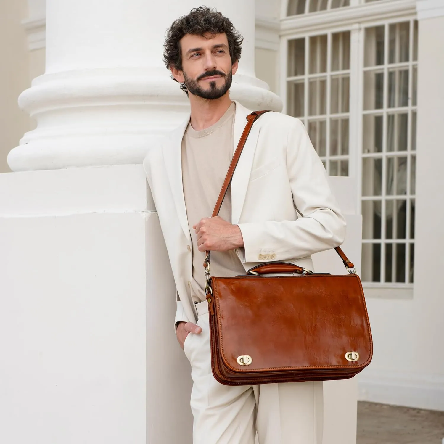 Man wearing Time Resistance leather briefcase with cream suit