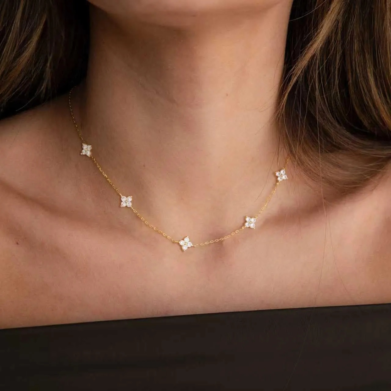 Gold and silver station necklaces displayed on a soft card