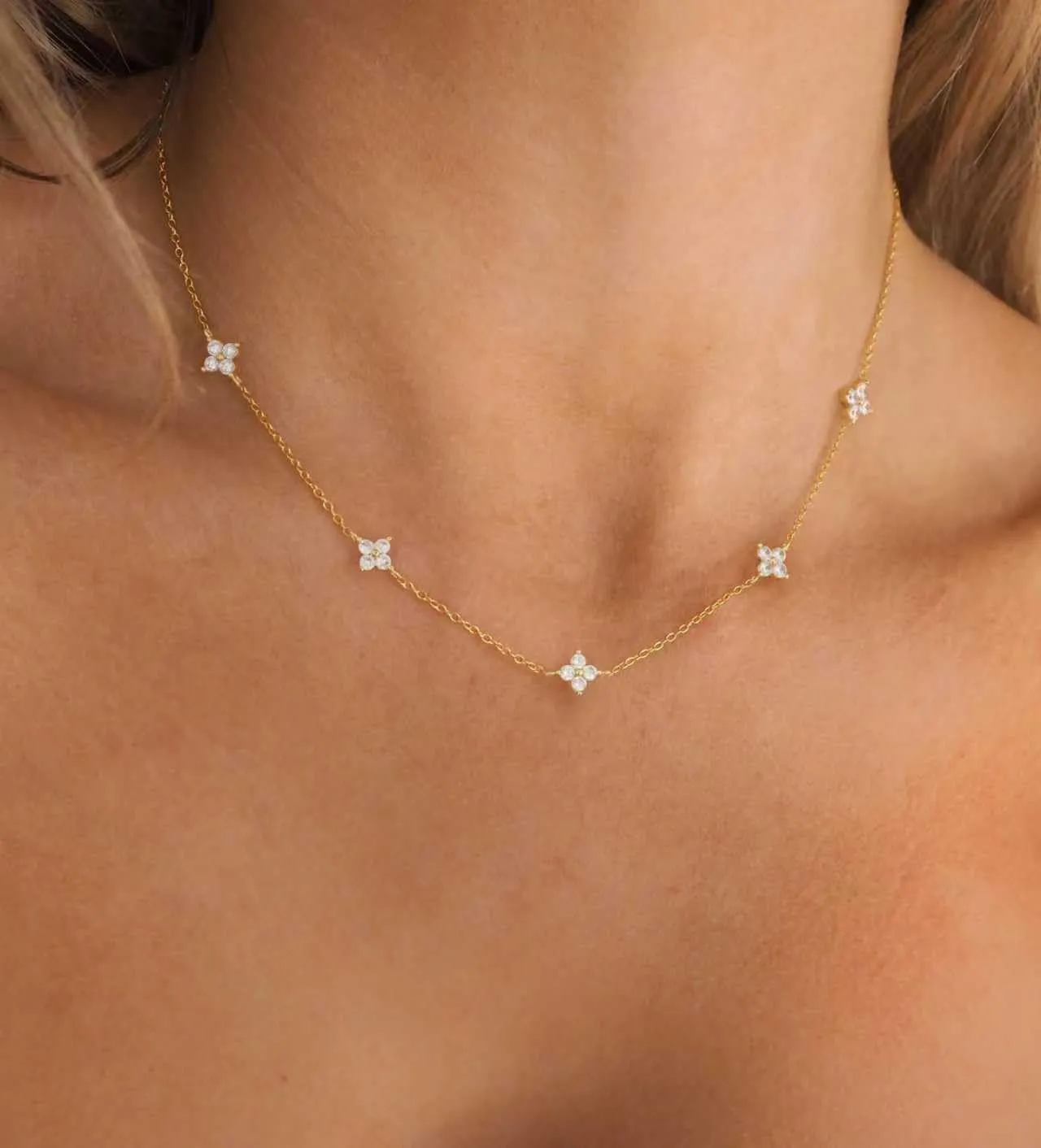 Layered gold station necklace with a heart pendant