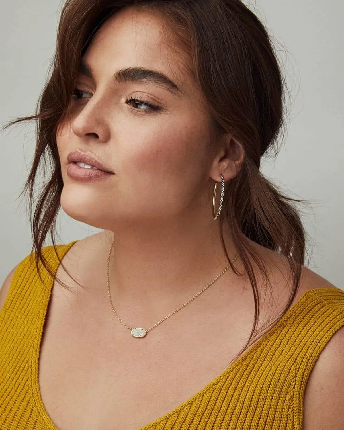 Kendra Scott Elisa pendant necklace worn with a yellow top
