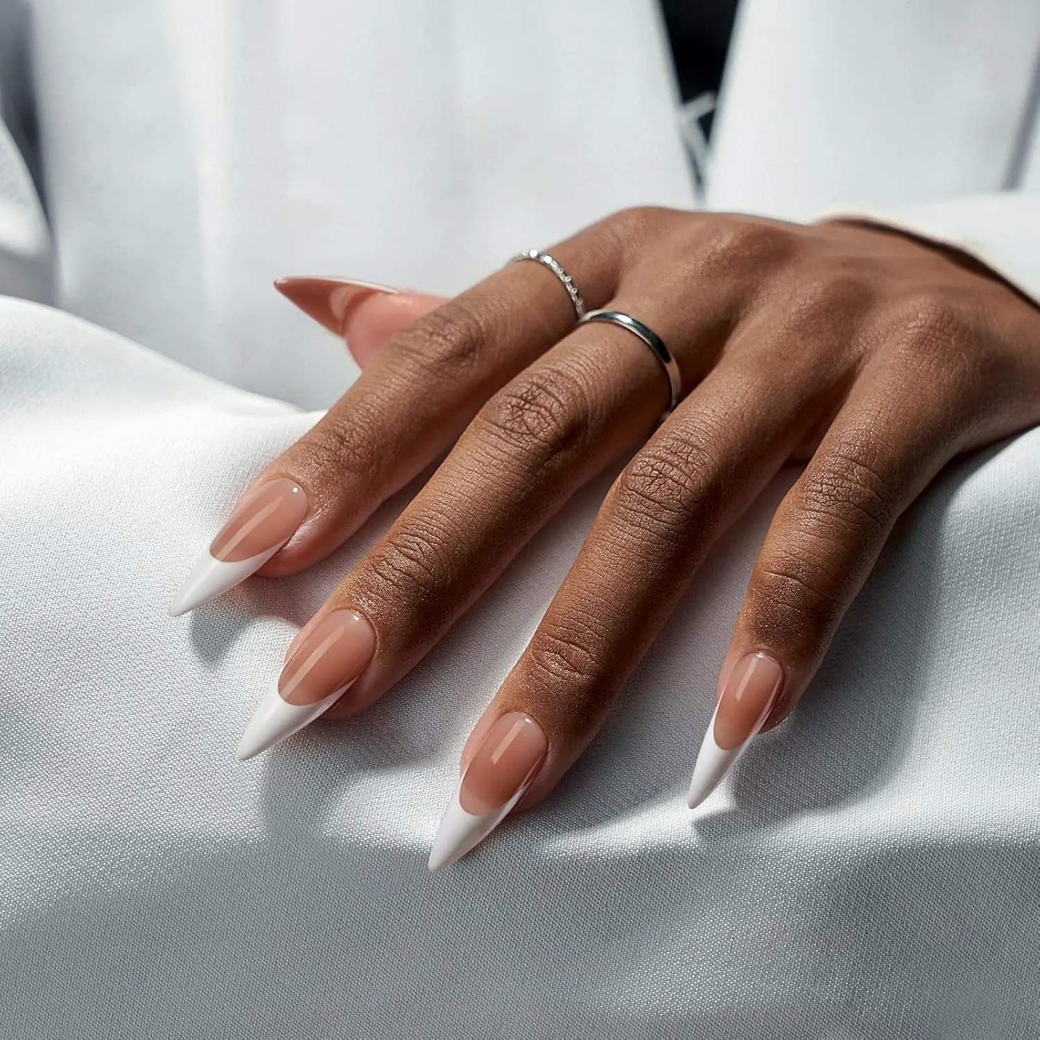 Brown and white stiletto French nails on hand