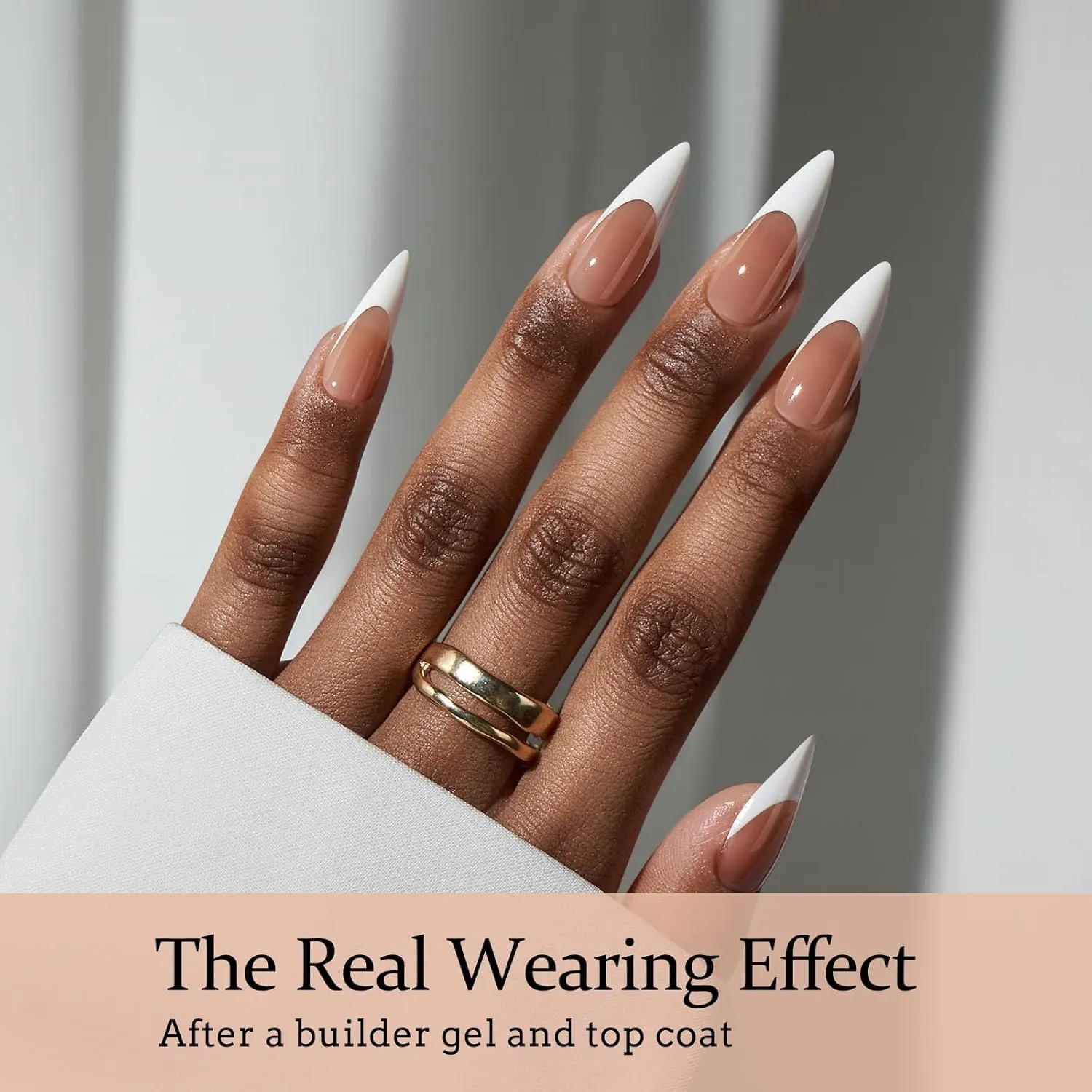 Close-up of brown stiletto French nails with rings