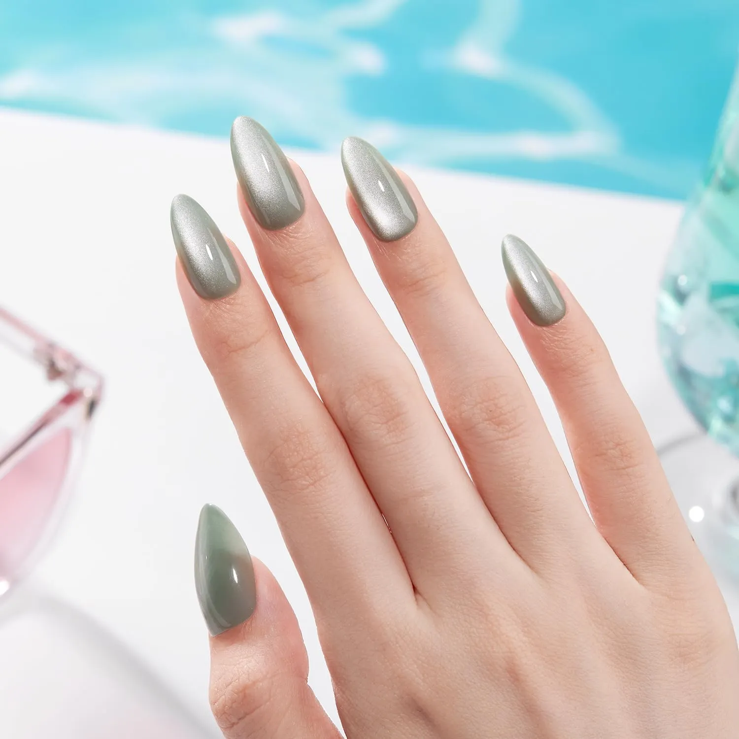 VSALON green cat eye chrome nails styled on a natural green background