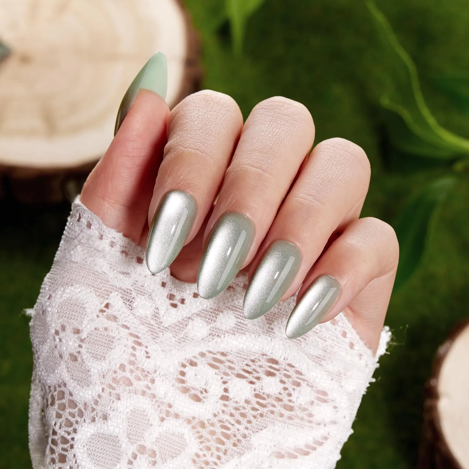 VSALON green shimmer almond nails with beach-inspired styling and neutral accessories